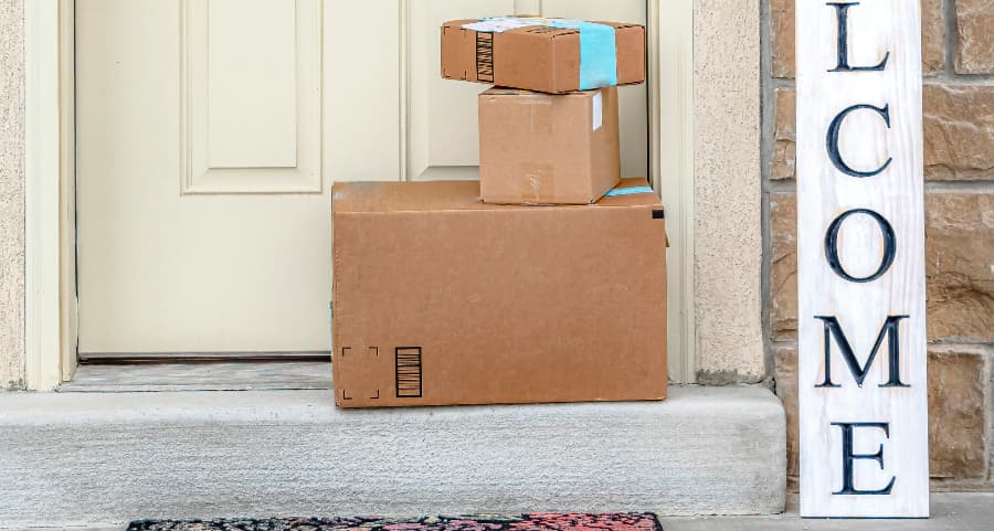 Deliveries on the front porch of a house with a welcome sign in Arlington